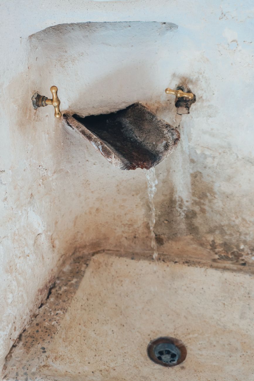 Hard Water vs Soft Water: Mineral Buildup on a Faucet Compared to Clean Glass