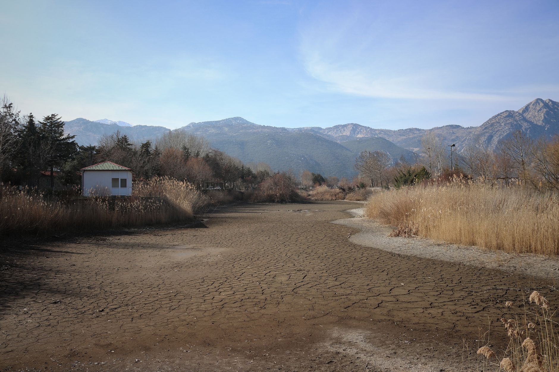 Dry riverbed in a Middle Eastern field, illustrating severe water scarcity.