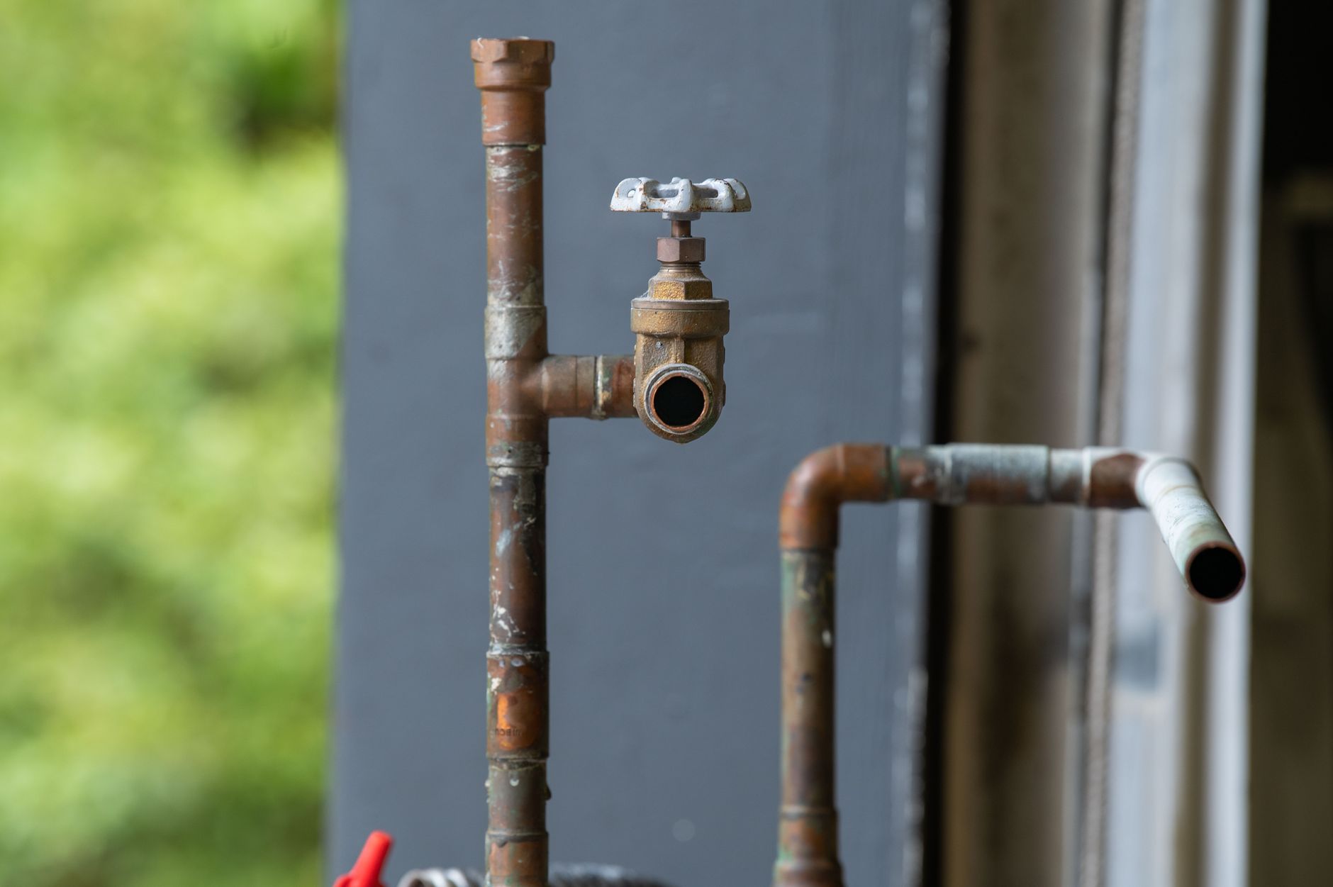 Blue air injection iron filter beside well pressure tank