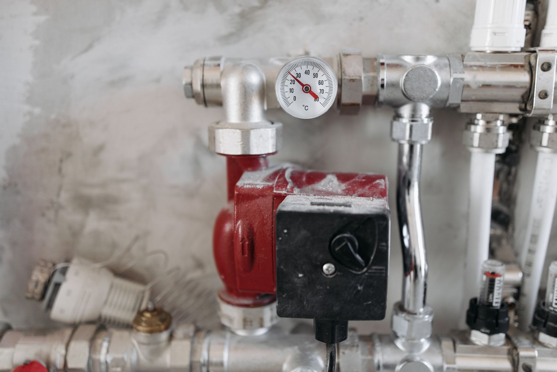 Booster pump and pressure gauge installed on basement water lines