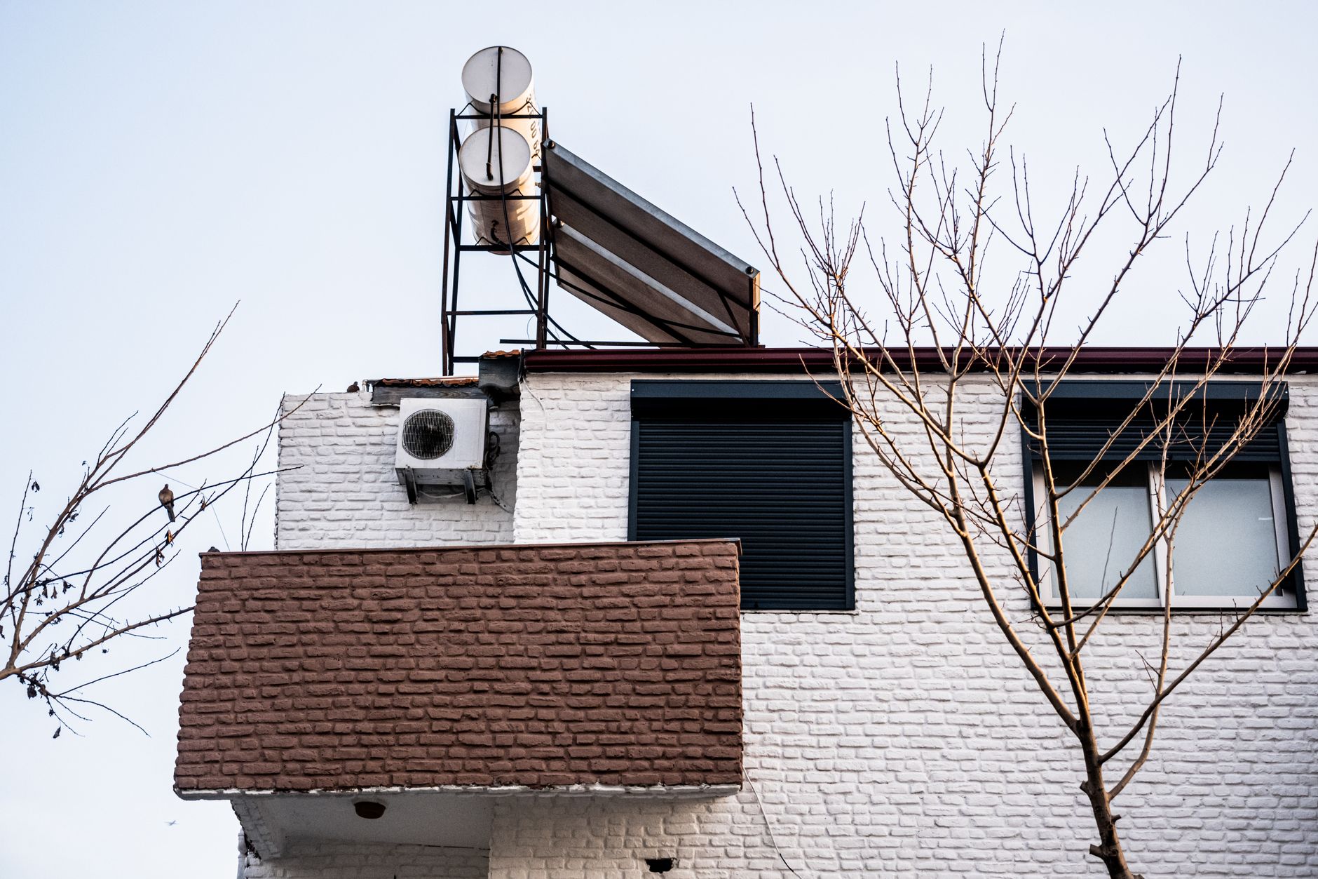 Flat plate solar water heater panels mounted on a sunny roof