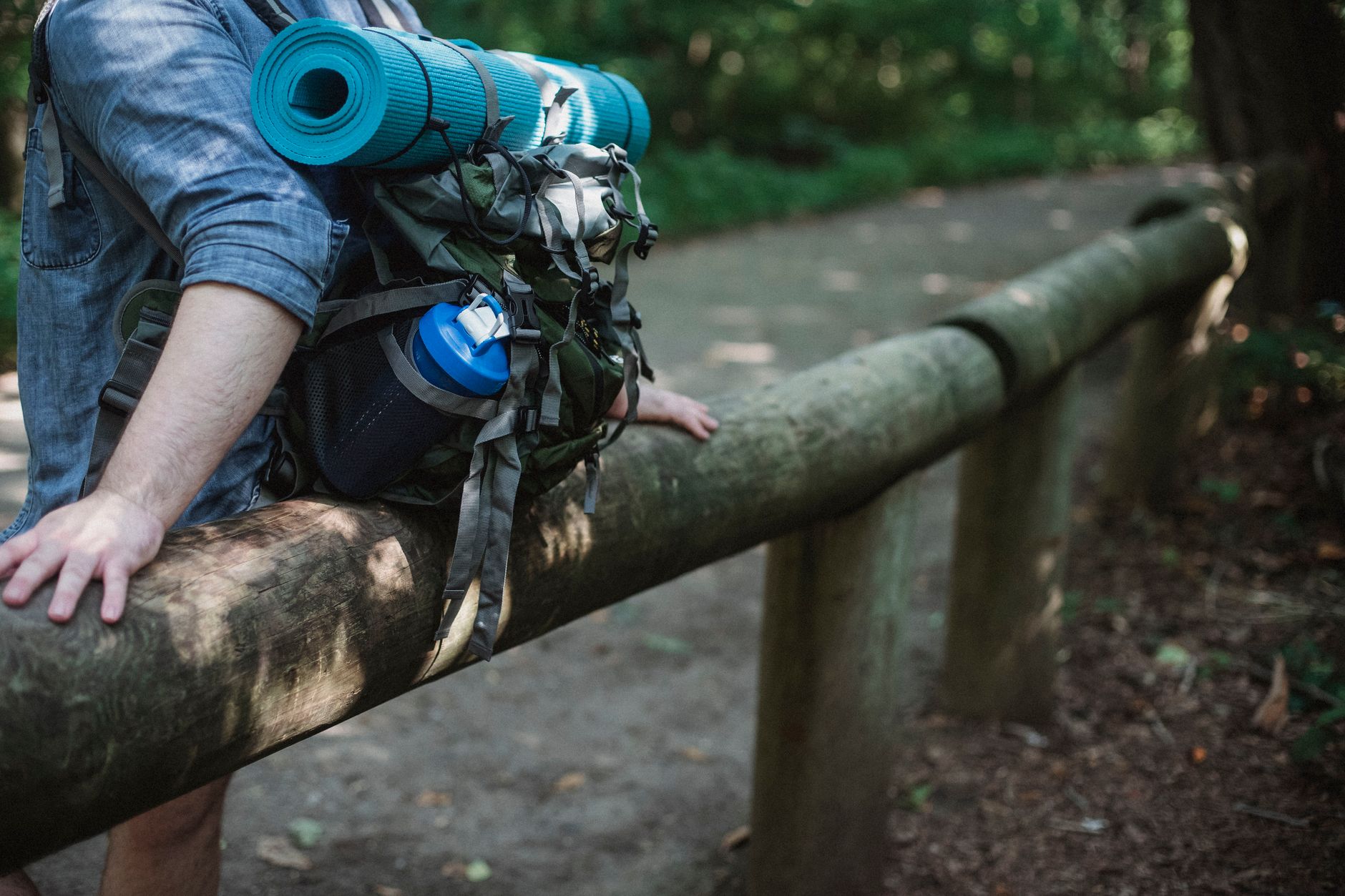 Hiker drinking from filtered water bottle on trail